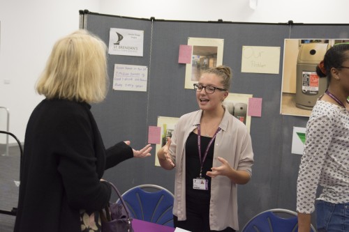 Aliza speaks to visitor