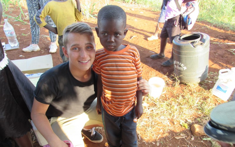 Kieran Long with child after removing jiggers